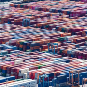 A wide array of shipping containers of various colours in a port.